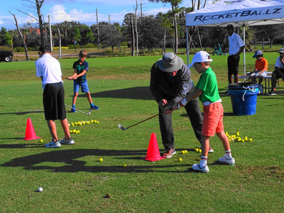 Glen Beaver helping a student with golf swing.