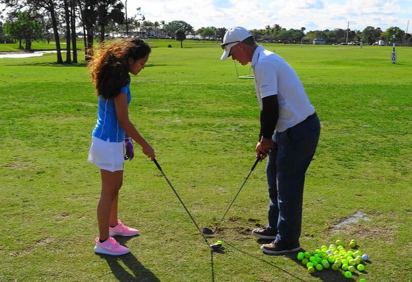 Glen Beaver helps students prepare for their high school golf team.