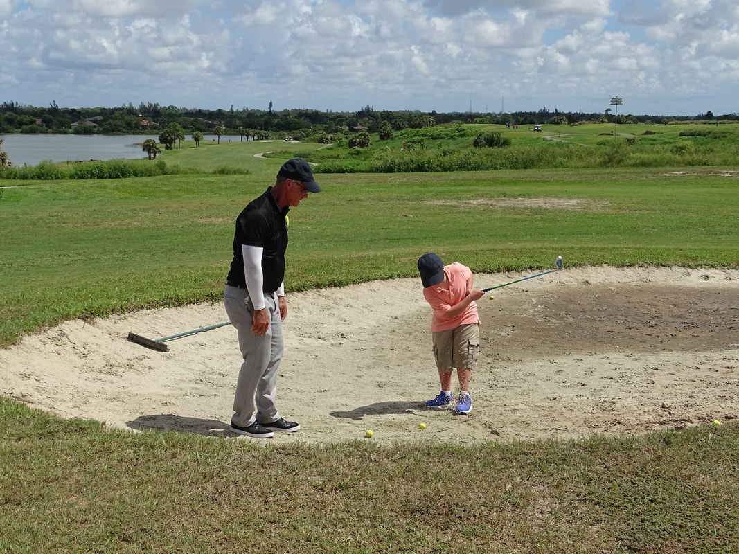 Glen Beaver coaching junior golf student at Park Ridge Golf Course