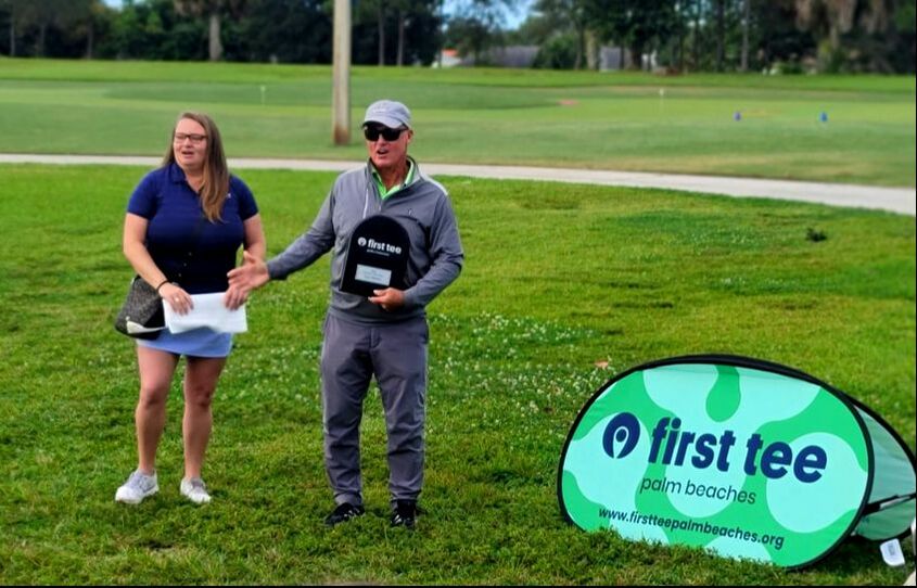 Emily Valentine presents Glen Beaver with Golf Coach of the Year of Award